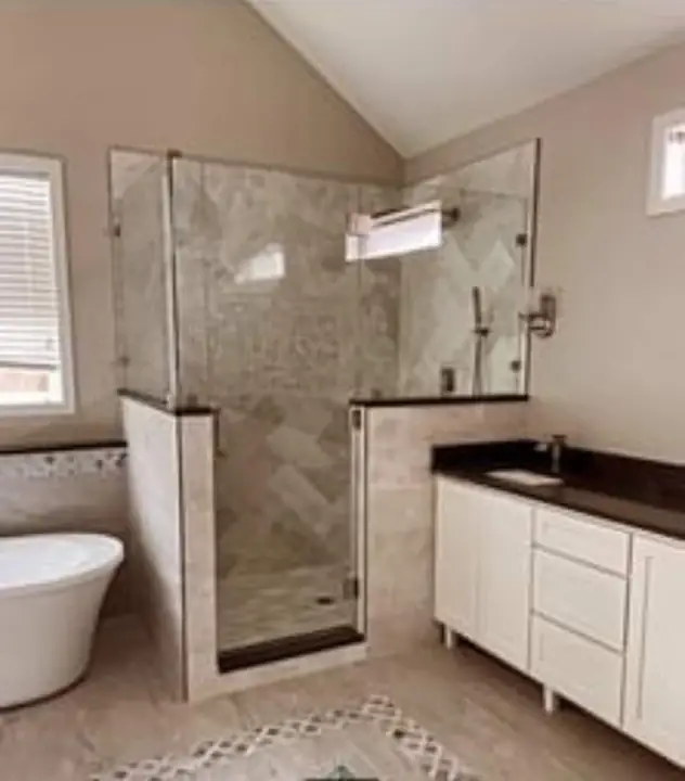 Shower beside the sink and cabinet, a TurnKey Bath Remodel project in New Orleans