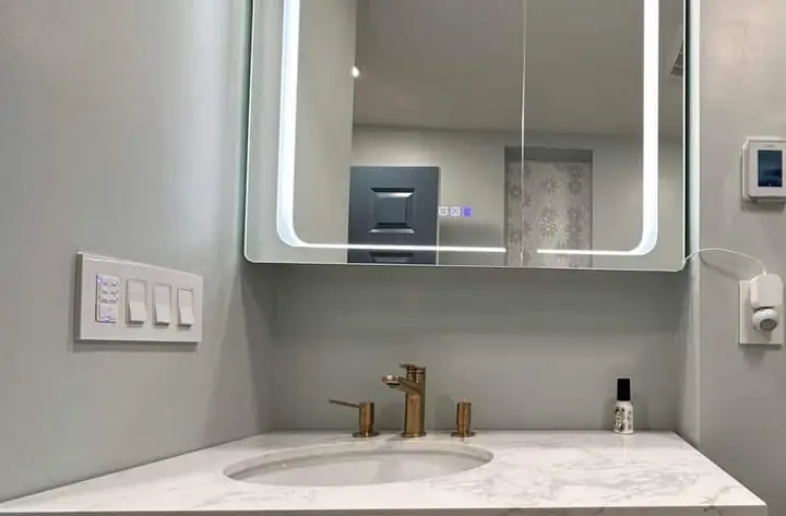 Sink with mirror beside the toilet, a TurnKey Bath Remodel project in New Orleans