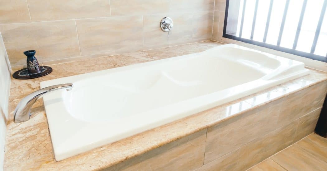 White bathtub in a budget-friendly New Orleans bathroom remodel