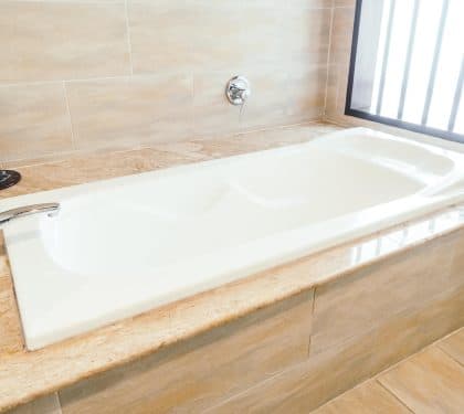 White bathtub in a budget-friendly New Orleans bathroom remodel