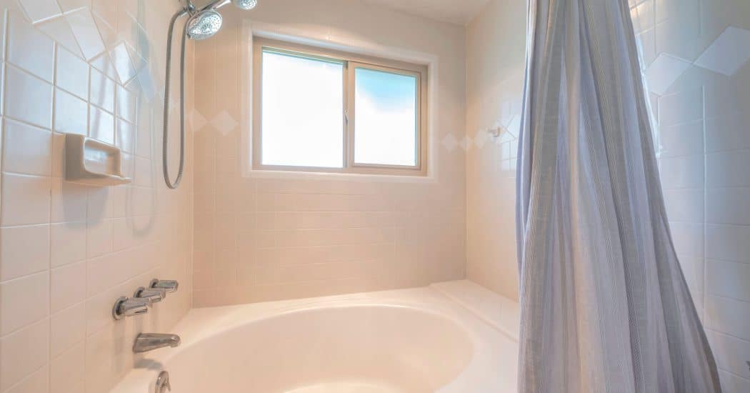 Bathtub and shower before a tub-to-shower conversion in New Orleans