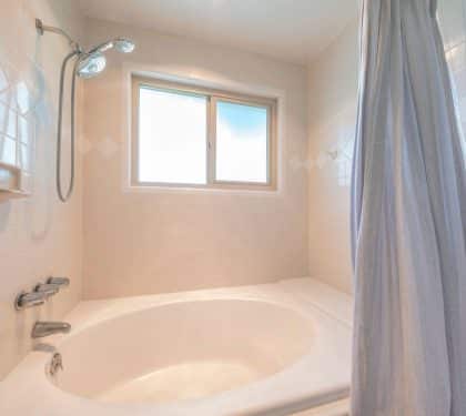 Bathtub and shower before a tub-to-shower conversion in New Orleans
