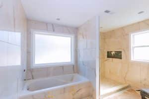 Bathroom shower under construction with new wall and floor tile in New Orleans
