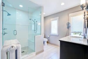 Finished walk-in shower with glass enclosure and tiled walls