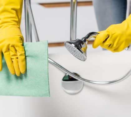 Cleaning a shower to help prevent mold in a New Orleans bathroom