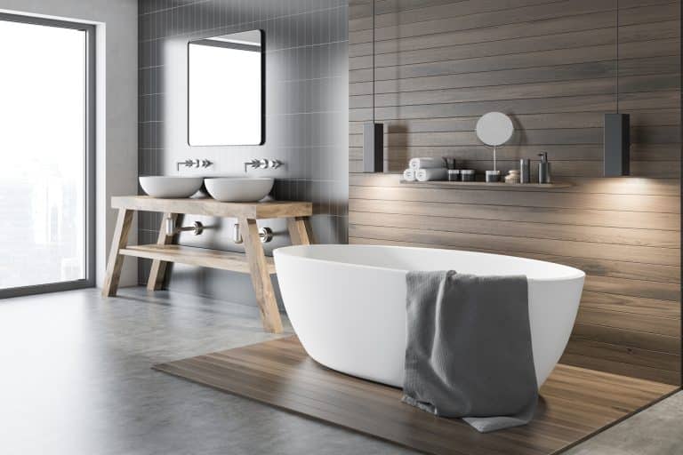 Modern bathroom with a freestanding tub and wood-look flooring
