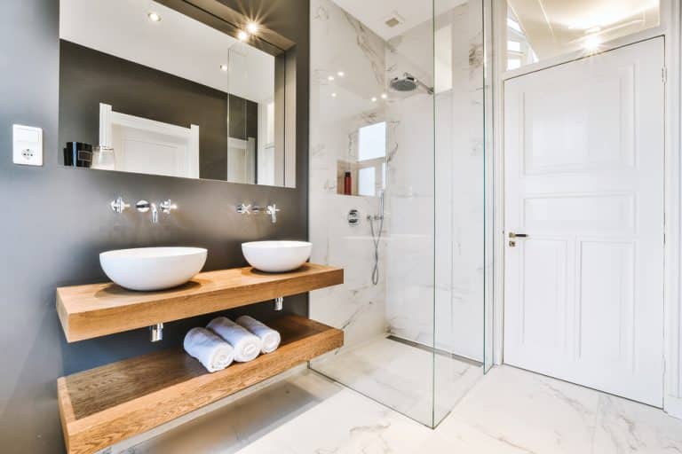 Elegant remodeled bathroom with a glass shower and double vanity