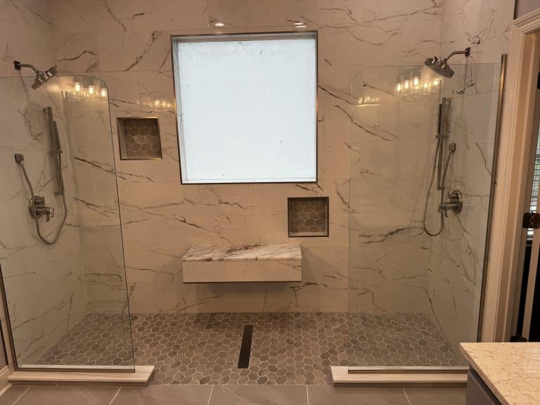 Two shower with a seat in the middle - Turnkey Bath Remodel